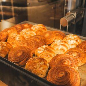 Freshly baked pastries sit on a tray.